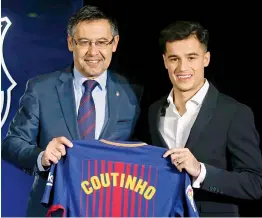  ?? AP ?? Philippe Coutinho ( right) with Barcelona president Josep Maria Bartomeu during his official presentati­on at the Camp Nou Stadium on Monday. —