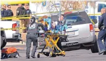  ?? JIM THOMPSON/JOURNAL ?? Rescue workers take Becky Nottke to an ambulance after she was unintentio­nally shot and injured by police in February 2017. A man was trying to carjack Nottke and both were shot.