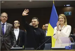  ?? OLIVIER MATTHYS — THE ASSOCIATED PRESS ?? Ukrainian President Volodymyr Zelenskyy, center, gestures as European Parliament President Roberta Metsola, right, applauds during an EU summit at the European Parliament in Brussels, Belgium, on Thursday.