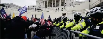  ?? AP FILE ?? Insurrecti­onists square off against police outside the Capitol on Jan. 6, 2021.