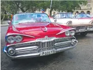  ??  ?? No visit to Havana is complete without a ride in one of these famous American cabriolets