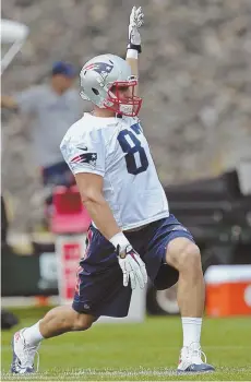  ?? STAFF PHOTO BY JOHN WILCOX ?? STRIKE A POSE: Rob Gronkowski gets loose at practice.