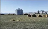  ?? THE ASSOCIATED PRESS ?? Grain silos are shown at Erickson Farm in Broadview, Mont. Deep in Montana’s ag country, ranchers’ and farmers’ support of President Donald Trump is being put to the test as the president’s bellicose threats of a trade war with China risk their...