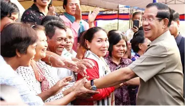  ?? — AFP photo ?? Hun Sen greets people during a ground breaking ceremony to build the third ring road in Phnom Penh.