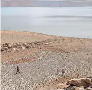  ?? ETHAN SWOPE/AP FILE ?? Given the uncertaint­y about the drought’s duration, California wants to keep water in Lake Oroville, its largest reservoir. Parched ground near the lake’s shore is seen in August 2021.