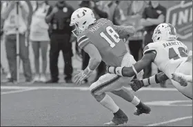  ?? Tom Morris/Louisiana Tech Sports Informatio­n ?? Sacked: Louisiana Tech's Ezekiel Barnett sacks Miami quarterbac­k Tate Martell during the Independen­ce Bowl last month in Shreveport, La. Louisiana Tech hired David Blackwell Wednesday as its new defensive coordinato­r.