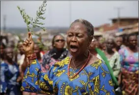  ?? (AP/Sunday Alamba)* ?? Funmilayo Iwaloye reacts Tuesday during a protest outside the Palace of Olowo of Owo following Sunday’s church attack at the St. Francis Catholic Church in the city. Before the church attack, Ondo had been considered one of Nigeria’s most peaceful states. But now Owo, a small town of traders and government workers located 31 miles from the state capital of Akure, is reeling from the violence of the church attack.