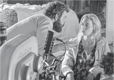  ??  ?? John Krasinski directs his wife, Emily Blunt, in the horror thriller “A Quiet Place.”