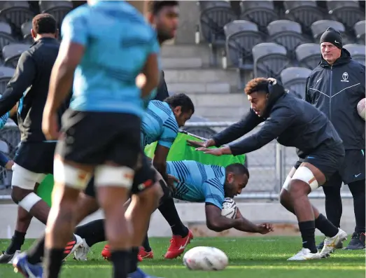  ?? Photo: FRU Media ?? Flying Fijians winger Manasa Mataele (with ball) taken to the ground by Kitione Kamikamica while head coach Vern Cotter looks on. The Flying Fijians face the All Blacks in the second Test at FMG Stadium Waikato in Hamilton on Saturday at 7.05pm.