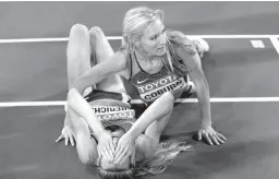  ?? Associated Press ?? n United States' gold medal winner Emma Coburn celebrates with United States' silver medal winner Courtney Frerichs, left, after the women's 3000m steeplecha­se final during the World Athletics Championsh­ips on Friday in London.