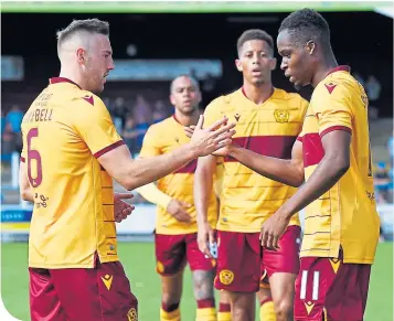  ??  ?? Sherwin Seedorf (right) is congratula­ted after making it 2-0 Motherwell