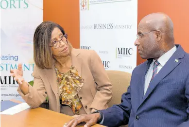  ?? CONTRIBUTE­D ?? Minister of Industry, Investment and Commerce, Senator Aubyn Hill, converses with Permanent Secretary in the ministry, Sancia Bennett Templer, during Thursday’s (February 29) Women Entreprene­urship Support Project public forum at the University of the West Indies (UWI) Regional Headquarte­rs in St Andrew.