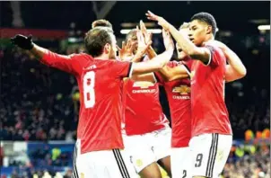  ?? OLI SCARFF/AFP ?? Manchester United striker Marcus Rashford (right) celebrates with teammates after scoring in their Champions League match with CSKA Moscow on Tuesday.