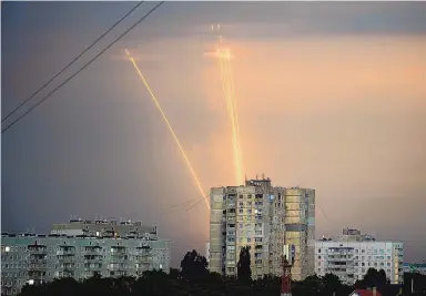  ?? VADIM BELIKOV/ASSOCIATED PRESS ?? Russian rockets are launched against Ukraine from Russia’s Belgorod region at dawn in Kharkiv, Ukraine, on Aug. 15. Eight months after Russian President Vladimir Putin launched an invasion against Ukraine expecting a lightning victory, the war continues, affecting not just Ukraine but also exacerbati­ng death and tension in Russia among its own citizens.