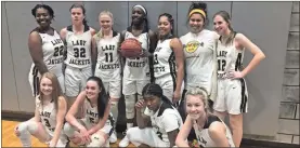  ?? / Lorene Parker ?? Teammates joined Keyarah Berry during a presentati­on for her 1,000 point award.