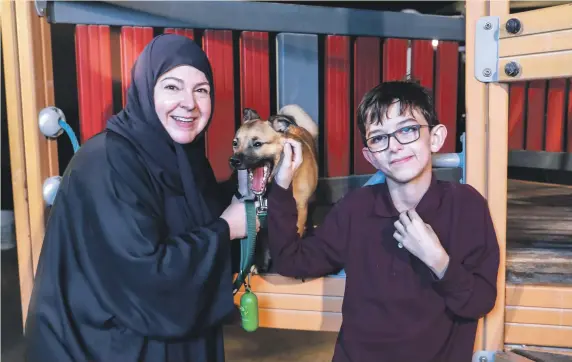  ?? Victor Besa / The National ?? Khawla Barley says her son, 11-year-old Abdulla Al Mansouri, has bonded closely with his pet dog Finn despite early efforts to separate them