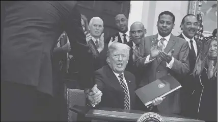  ?? AP photo ?? President Donald Trump shakes hands in the Roosevelt Room of the White House during an event to honour Dr. Martin Luther King Jr. Africans were shocked on Friday by comments President Donald Trump had made regarding immigrants.