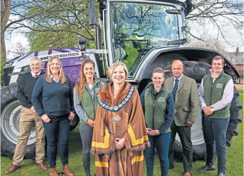  ?? ?? LOVELY LIVERY: Worshipful Company of Farmers Master Karen Mercer, centre, joins NFU, Massey Ferguson and KO Machines representa­tives to unveil the special tractor.