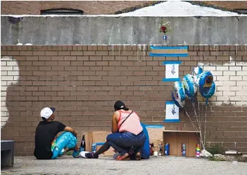  ?? AP PHOTOS ?? TAKEN TOO SOON: Mourners, above, visit a memorial yesterday for Antiq Hennis, pictured left, in the Brownsvill­e neighborho­od of Brooklyn, New York. Hennis, 1, was killed Sunday by a bullet police say was meant for his father.