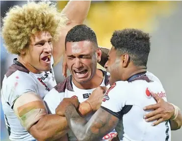  ??  ?? Marcelo Montoya (middle) is hugged by Eloni Vunakece and Kevin Naiqama after the Vodafone Fijian Bati scored an upset 4-2 win over New Zealand at the 2017 World Cup in Eden Park, Auckland.