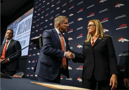  ?? AARON ONTIVEROZ — THE DENVER POST ?? Broncos head coach Sean Payton, center, shakes hands with owner Carrie Walton Penner during an introducto­ry press conference at team headquarte­rs in Englewood on Monday.
