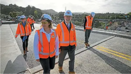  ?? JARRED WILLIAMSON/STUFF ?? Peter Dilley, front right, gets his first walk across the bridge with CPB Contractor­s and NZTA staff.