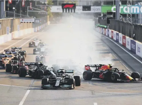  ??  ?? 0 Lewis Hamilton locks up under pressure from eventual race winner Sergio Perez during the Azerbaijan Grand Prix