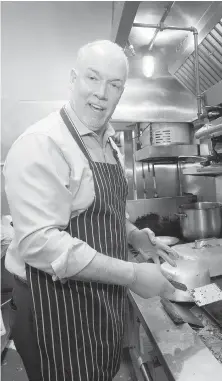  ?? DARRYL DYCK, CP ?? NDP Leader John Horgan works at the grill during a campaign stop at Burger Heaven in New Westminste­r on Monday. The restaurant runs a poll with burgers named after B.C. political leaders.