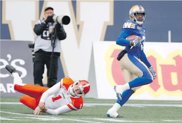  ?? — CP ?? Blue Bombers defensive back Kevin Fogg returns a Ty Long punt for a touchdown Saturday as the hosts held off a late surge by the Lions for a 26-20 win in Winnipeg. Fogg also picked off a Jonathon Jennings pass as the B.C. offence struggled for much of...