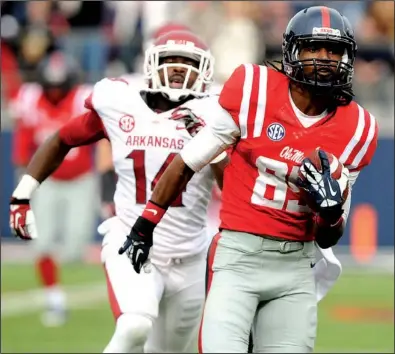  ?? NWA Media/SAMANTHA BAKER ?? Ole Miss wide receiver Ja-Mes Logan (right) runs away from Arkansas defensive back Eric Bennett for a 75-yard third-quarter touchdown that gave the Rebels a 10-point lead in what became a 34-24 victory Saturday in Oxford, Miss.