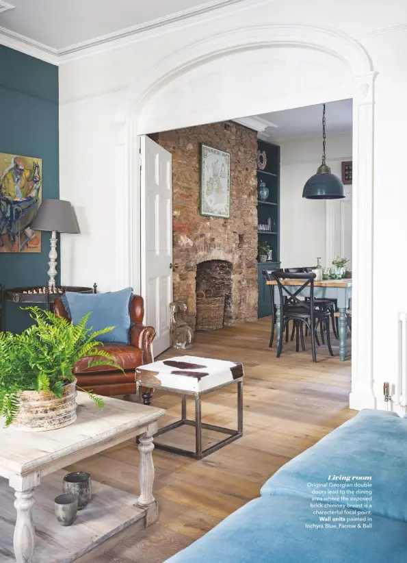  ??  ?? Living room
Original Georgian double doors lead to the dining area where the exposed brick chimney breast is a characterf­ul focal point. Wall units painted in Inchyra Blue, Farrow & Ball