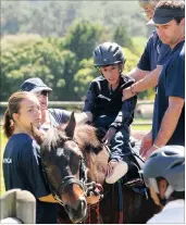  ??  ?? Rider Rayyaan Davids with volunteers Aniko Glass, Adrian Powell, Karen Basson and James Ball.