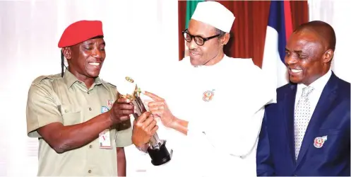  ?? Photo: Felix Onigbinde ?? From left: Minister of Youth and Sports, Barrister Solomon Dalung; President Muhammadu Buhari; and Permanent Secretary, Mr Chinyeaka Ohaa, as President Buhari receives GLO CAF Platinum Award for Good Leadership at the State House in Abuja yesterday.