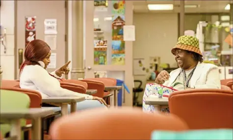  ?? Steve Mellon/Post-Gazette photos ?? Deborah Smith-Glover, 62, left, and Charlotte Walters, 69, chat while cooling off at the South Side Market House Healthy Active Living center. Ms. Smith-Glover is recreation leader at the center; Ms. Walters is from the Hill District. “This is a big family,” Ms. Walters said. “Everybody treats you so well — especially Deborah. She’s the ‘Welcoming Committee.’”