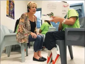  ?? PHOTO COURTESY OF TULARE COUNTY SHERIFF'S OFFICE ?? Kim Torrez, family program manger for the Tulare County Library, listens to an inmate read a children's book as part of the Mother/father Read Program Sept. 4, 2018 at the Adult Pre-trial Facility.