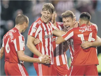  ??  ?? Max Power celebrates his goal with his team-mates.