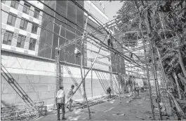  ??  ?? Workers make arrangemen­ts for the Lok Sabha poll results, at BJP Headquarte­rs in New Delhi on Monday.