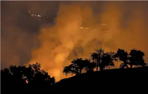  ?? AP PHOTO MARCIO JOSE SANCHEZ ?? A wildfires creates an orange glow in a view from a hilltop Friday in Geyservill­e, Calif.