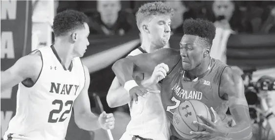  ?? PATRICK SEMANSKY/ASSOCIATED PRESS ?? Maryland forward Bruno Fernando, right, drives against Navy center Evan Wieck and guard Cam Davis (22) in the first half of Friday night’s game in the Veterans Classic at Alumni Hall.