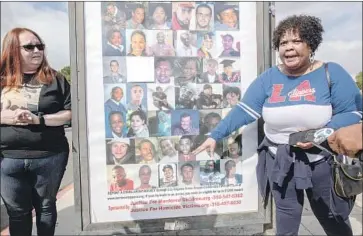  ?? Photograph­s by Allison Zaucha For The Times ?? FONDA JORDAN, right, who lost two relatives to gun violence, stands next to a poster of homicide victims.