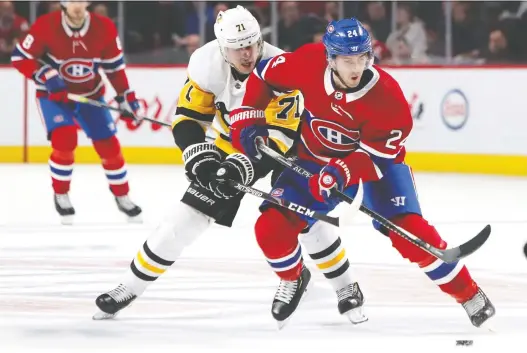  ?? JEAN-YVES AHERN/USA TODAY SPORTS FILE ?? Canadiens centre Phil Danault is checked by the Pittsburgh Penguins’ Evgeni Malkin during a game at the Bell Centre earlier this season. The Penguins won that game 3-2 in overtime and are heavily favoured when the two teams meet again in the best-of-five qualifying round for this year’s NHL playoffs.