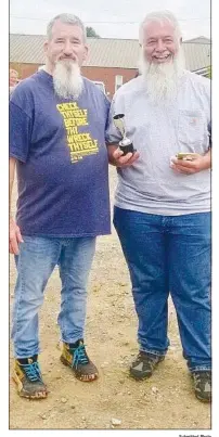  ?? Submitted Photo ?? Dwight Luper, of Siloam Springs, has a big smile just after Chris Crose presented him the trophy for Best of Show in the 2021 Gravette Day car show. Luper also won third place in the truck division with his 1971 C10 Chevy.