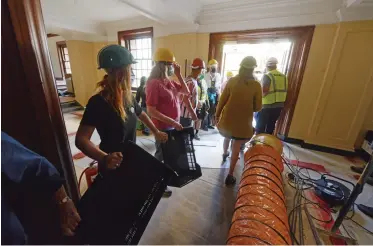  ?? Armand Hough/African News Agency(ANA) ?? VOLUNTEERS form a human chain to move documents, artifacts and books from the basement of the Jagger Library at UT after most of the building was destroyed in last week’s fire.