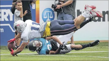  ?? STEVEN SENNE / ASSOCIATED PRESS ?? Patriots receiver Julian Edelman reaches for the ball as the Jaguars’ Tyler Patmon defends Monday. The teams are practicing together ahead of their exhibition game Thursday in Foxborough, Mass.