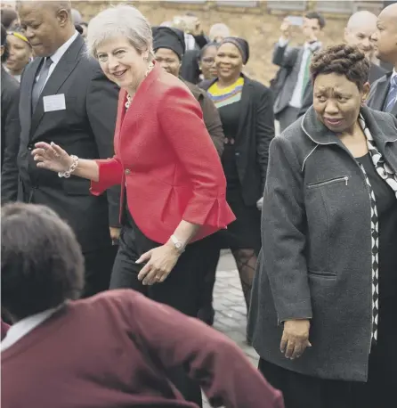  ?? PICTURE: RODGER BOSCH/AFP/GETTY ?? 0 It’s the end of the world as we know it and Theresa feels fine as she dances in Cape Town