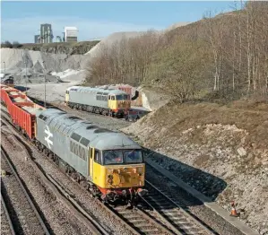  ?? ROBERT FALCONER. ?? GB Railfreigh­t 56098 brings out a loaded train at Peak Forest on March 28, while GBRf 56081 rests in the background. The ‘56s’ are used for shunting the heavy aggregates trains here, but will both be re-engineered in the future.