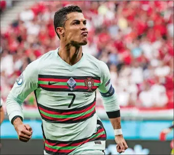  ?? BERNADETT SZABO/POOL VIA AP ?? Portugal’s Cristiano Ronaldo celebrates after scoring his second goal during a 3-0 win over Hungary on Tuesday in a Euro 2020 soccer Group F match in Budapest.