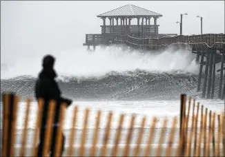  ?? CHIP SOMODEVILL­A / GETTY IMAGES ?? Waves crash underneath the Oceana Pier as the outer bands of Hurricane Florence begin to affect the coast in Atlantic Beach, N.C. Coastal cities in North Carolina, South Carolina and Virginia were under evacuation orders as the hurricane approached the coast Friday.