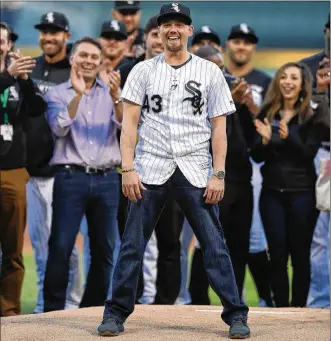  ?? CHRIS SWEDA / CHICAGO TRIBUNE ?? Recovering White Sox pitcher Danny Farquhar reacts after throwing out the ceremonial first pitch before a game against the Brewers at Guaranteed Rate Field in Chicago on June 1.