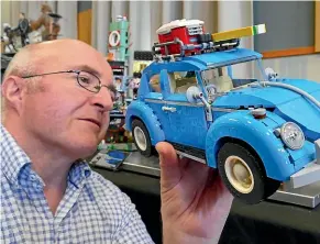  ??  ?? Greg Braddock checks out a Lego VW Beetle on display at the Internatio­nal Plastic Modeller Society Southland Model and Toy Expo and Competitio­n in Invercargi­ll. JOHN HAWKINS/STUFF